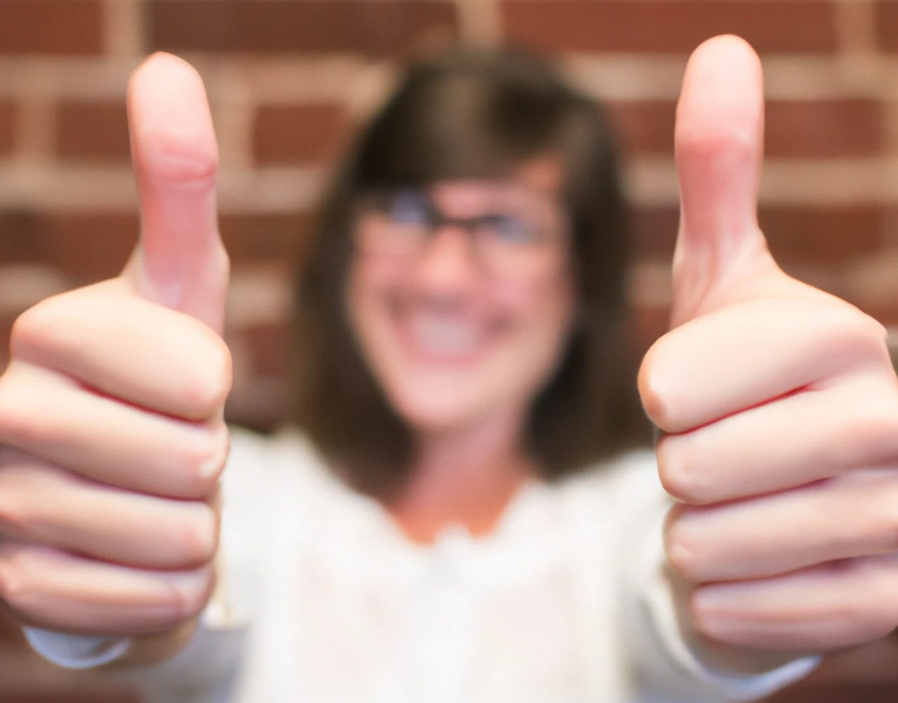 A woman gives two thumbs up