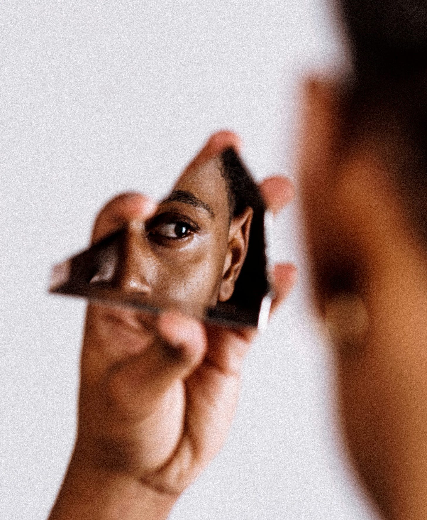 man holding broken mirror man holding broken mirror