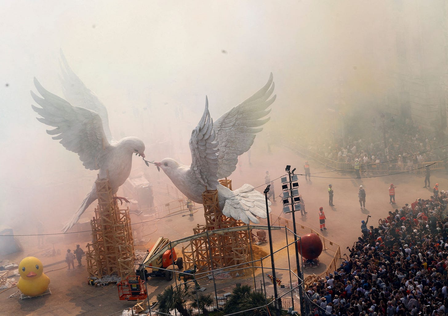 Smoke hides 'ninots' or giant figures depicting doves of peace fighting over an olive branch by artist Escif, and the buildings of Plaza del Ayuntamiento during the 'Mascleta', an explosive barrage of firecrackers and fireworks during the traditional annual Fallas Festival, in Valencia, Spain, on March 15.Eva Manez—Reuters. Smoke hides 'ninots' or giant figures depicting doves of peace fighting over an olive branch by artist Escif, and the buildings of Plaza del Ayuntamiento during the 'Mascleta', an explosive barrage of firecrackers and fireworks during the traditional annual Fallas Festival, in Valencia, Spain, on March 15.Eva Manez—Reuters.