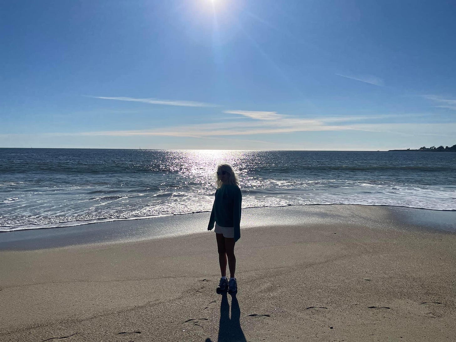 Woman standing alone on beach