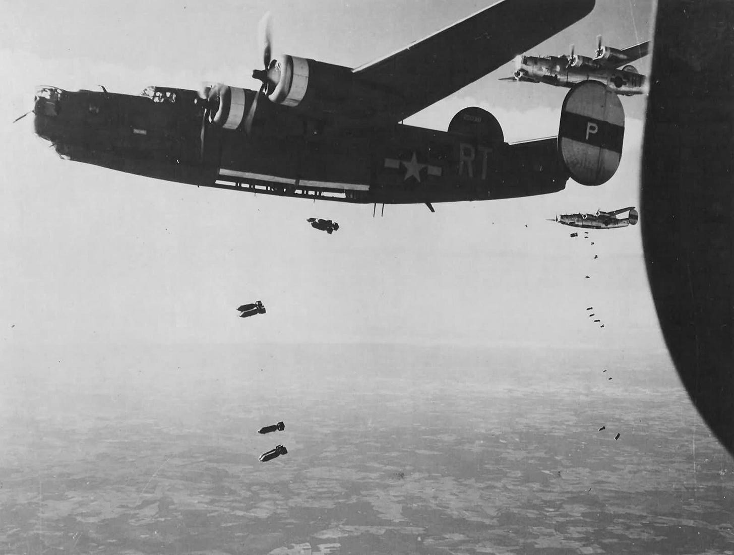 Formidable B-24 Liberators of the 446th Bomb Group, 8th Air Force, unleash their ordnance on enemy targets in 1944, a powerful display of WWII aerial might.
