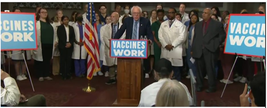 A person standing at a podium with a sign and a group of people in the background

AI-generated content may be incorrect.