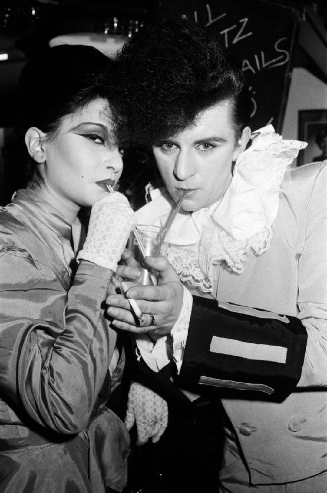 Princess Julia and Steve Strange share a cocktail with straws at the Blitz Club