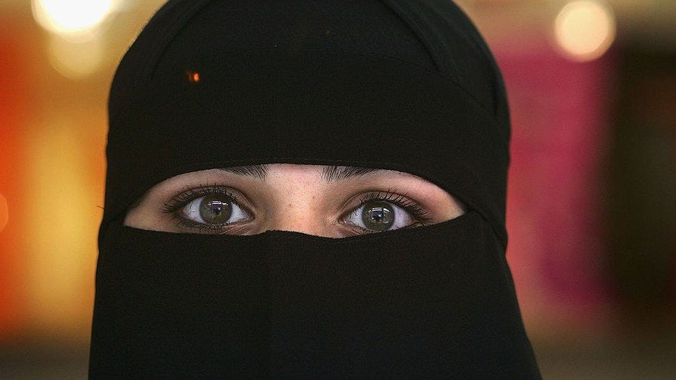 BLACKBURN, UNITED KINGDOM - OCTOBER 06: A Muslim woman wearing a Niqab poses inside an Asian fashion shop in the British northern town of Blackburn, the constituency of Member of Parliament Jack Straw, where a quarter of his constituents are Muslim on October 6, 2006, Blackburn, England. Leader of the House of Commons Jack Straw has said that he asked Muslim women attending his Blackburn constituency surgeries if they would mind removing veils. The comments have caused anger within the Muslim community.