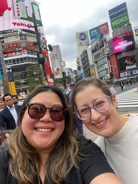 A collage of nine photos from travels in Japan: two sumo wrestlers posing with visitors; vintage kabuki posters on display; a small group sitting on tatami mats during a cultural workshop; a mannequin dressed in a traditional kimono with floral patterns; three people smiling in front of a lantern-filled temple gate; a night market vendor grilling skewers and takoyaki; two friends taking a selfie in Shibuya among bright city signs; the waterfront skyline and Ferris wheel in Yokohama; and a narrow alleyway in Kyoto lined with glowing izakaya lanterns.