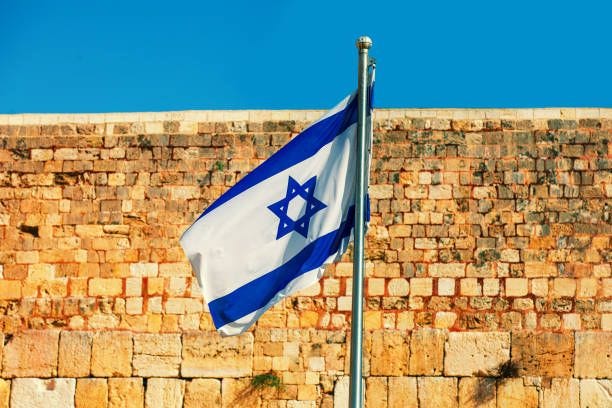 The Israeli flag flies at the Western Wall in Jerusalem in Israel The Israeli flag flies at the Western Wall in Jerusalem in Israel jerusalem flag stock pictures, royalty-free photos & images
