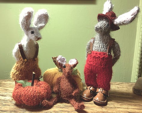 Two rabbits, discover a kiddy rabbit, in the pumpkin patch. They sit hi on a chair and have a cuddle.