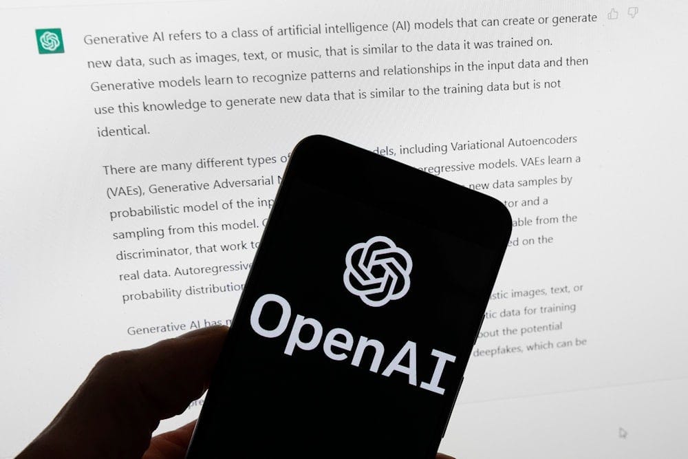 The OpenAI logo is seen on a mobile phone in front of a computer screen displaying output from ChatGPT, March 21, 2023, in Boston (AP) The OpenAI logo is seen on a mobile phone in front of a computer screen displaying output from ChatGPT, March 21, 2023, in Boston (AP)
