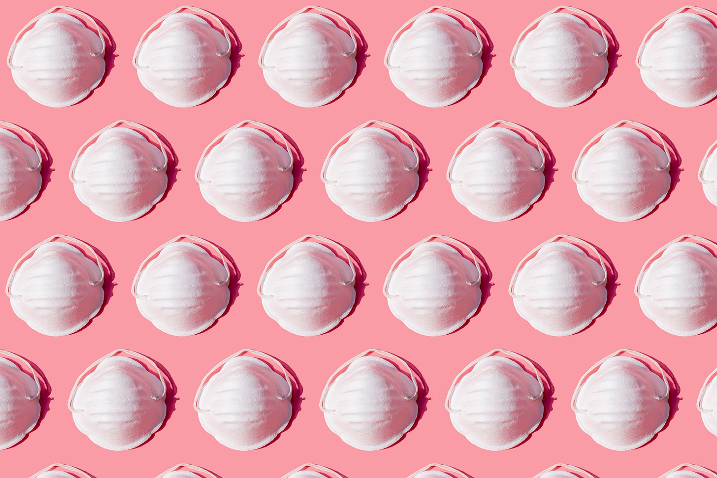White masks on a pink background.