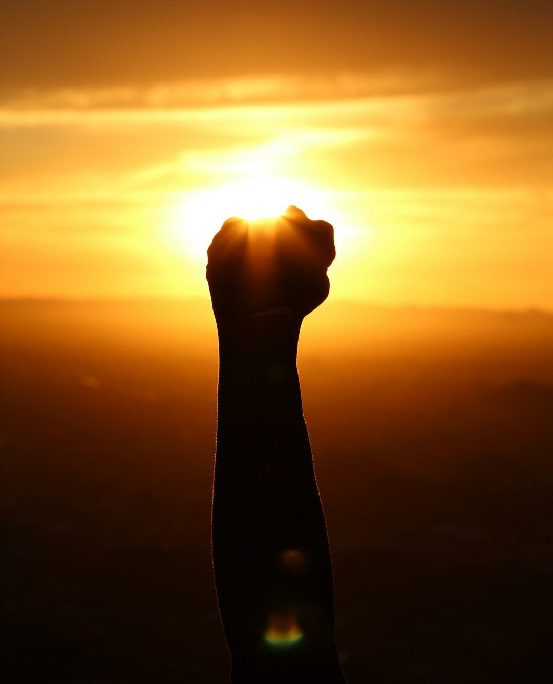 silhouette of person fist during sunset silhouette of person fist during sunset
