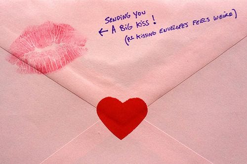 This may contain: an envelope with a heart and lipstick on it This may contain: an envelope with a heart and lipstick on it