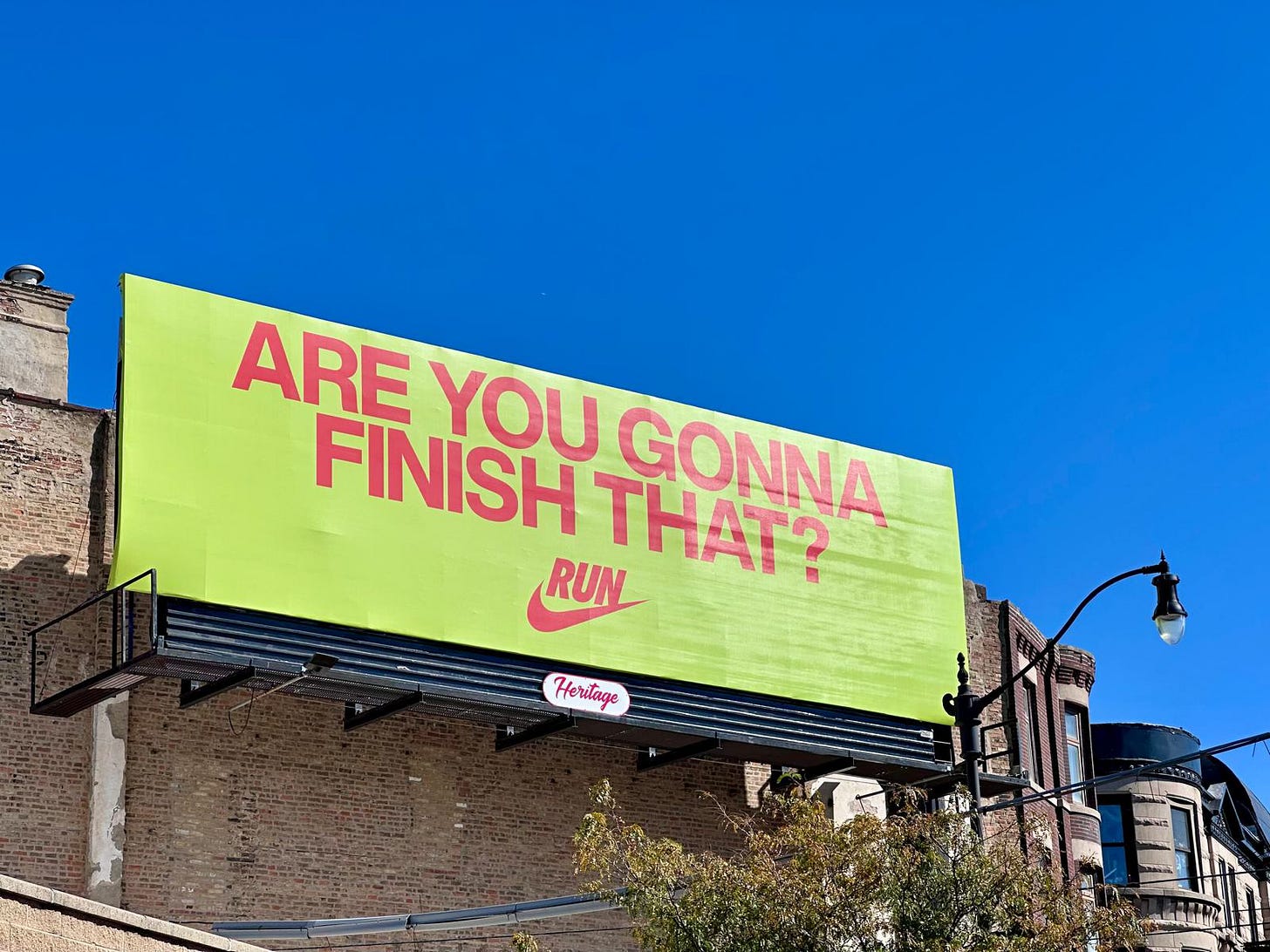 Nike billboard along the Chicago Marathon course reading “Are you gonna finish that?” under a clear blue sky.