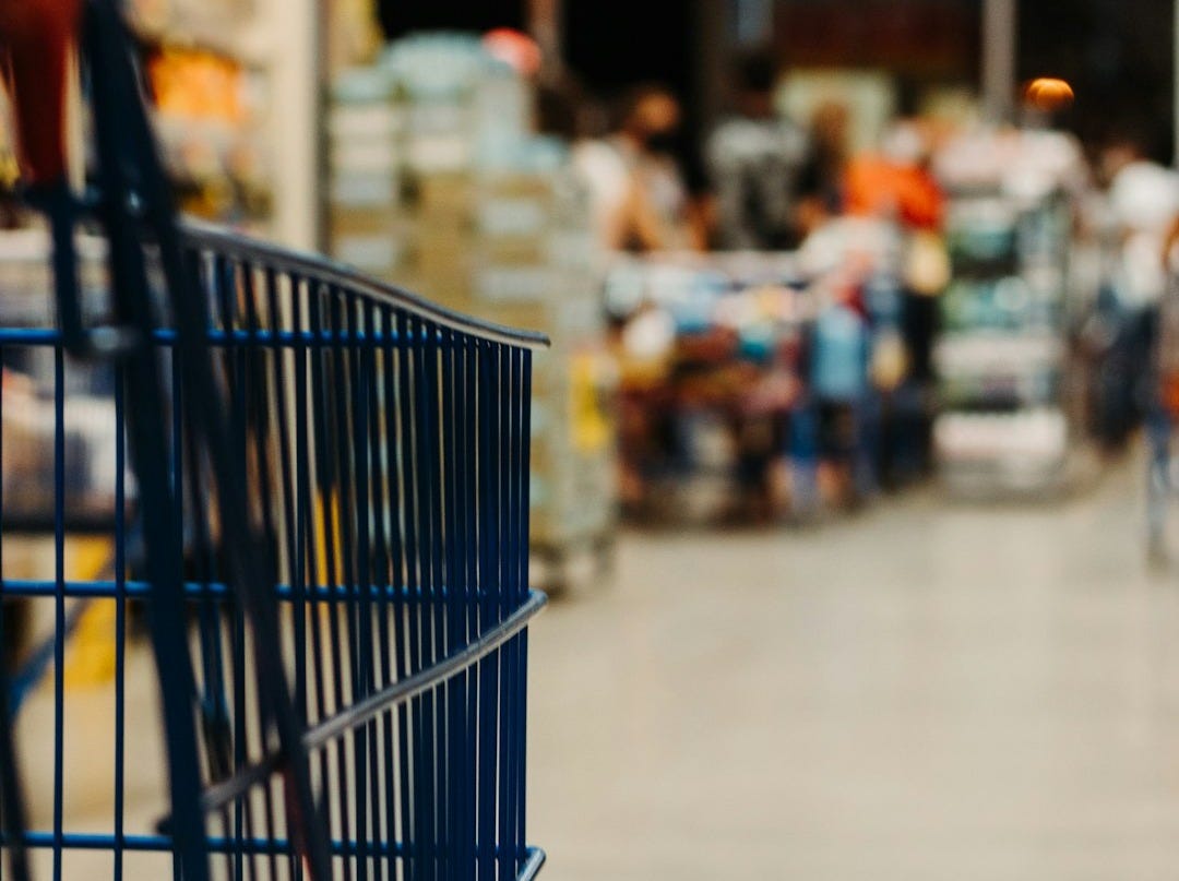 blue shopping cart on street during daytime blue shopping cart on street during daytime