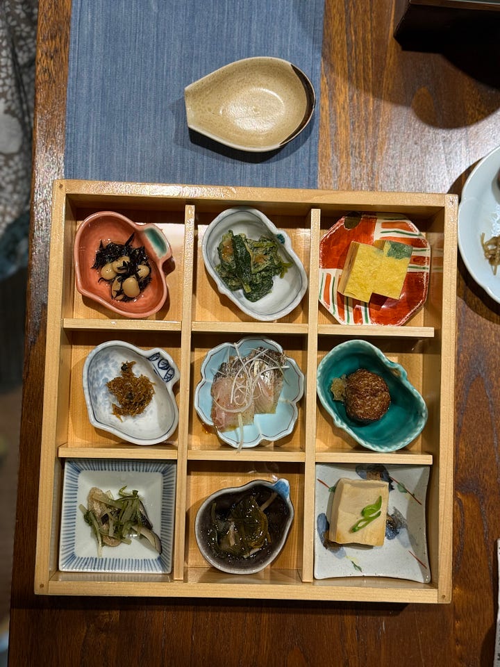 Four images of a traditional Korean and Japanese breakfast spread — grilled mackerel, rice congee with scallions, an assortment of banchan side dishes, and miso soup with tofu.