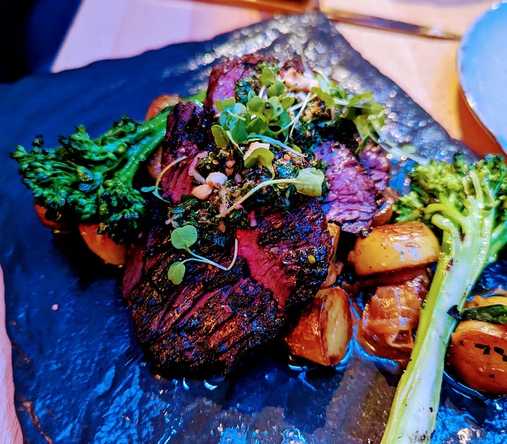 Left to right: Shoyu salmon (salmon on top of rice and covered with herbs and broccolini); Hanger steak (hanger steak accompanied by potatoes, broccolini, topped with hazelnuts and salsa verde)