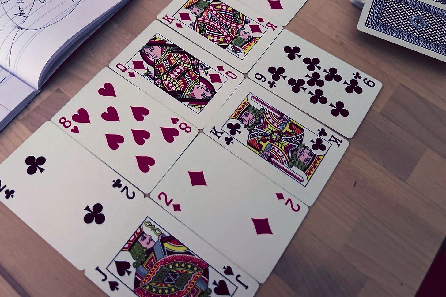 Some playing cards laid out on the table in two rows