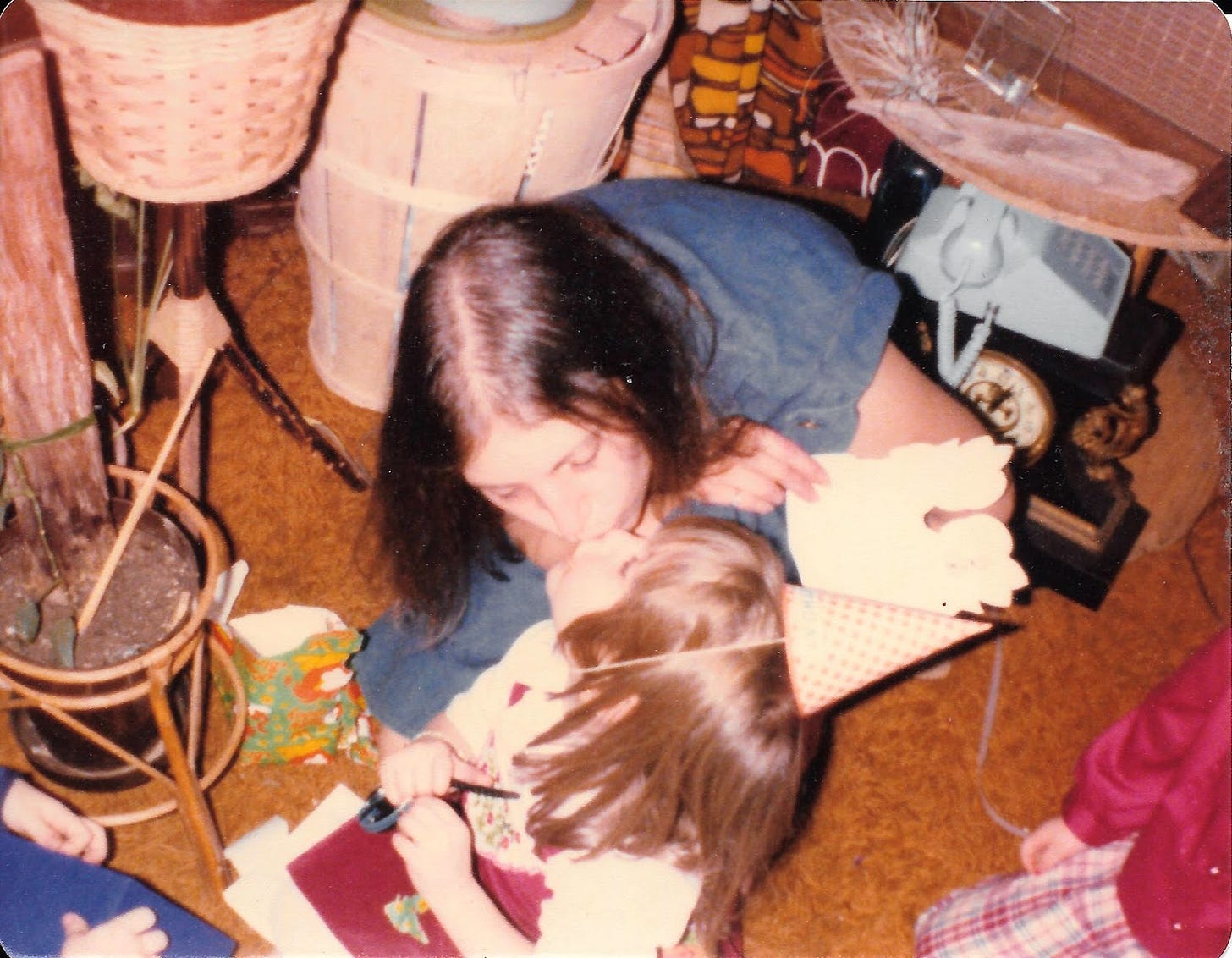 Photo from late 70s of my mom kissing a 3-year old me, wearing a birthday party hat