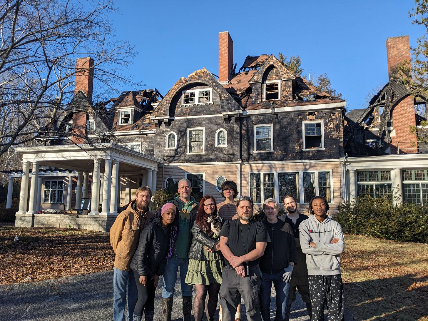 Some of the survivors from the Oakhurst Manor fire and fellow residents standing in front of the condemned manor building. Some of the survivors from the Oakhurst Manor fire and fellow residents standing in front of the condemned manor building.