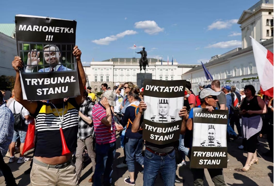 A group of people holding signs

AI-generated content may be incorrect.