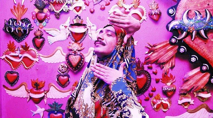 A fabulous queer poses in front of the decorations at La Purisima. The rainbow colored doors of La Puri by day.