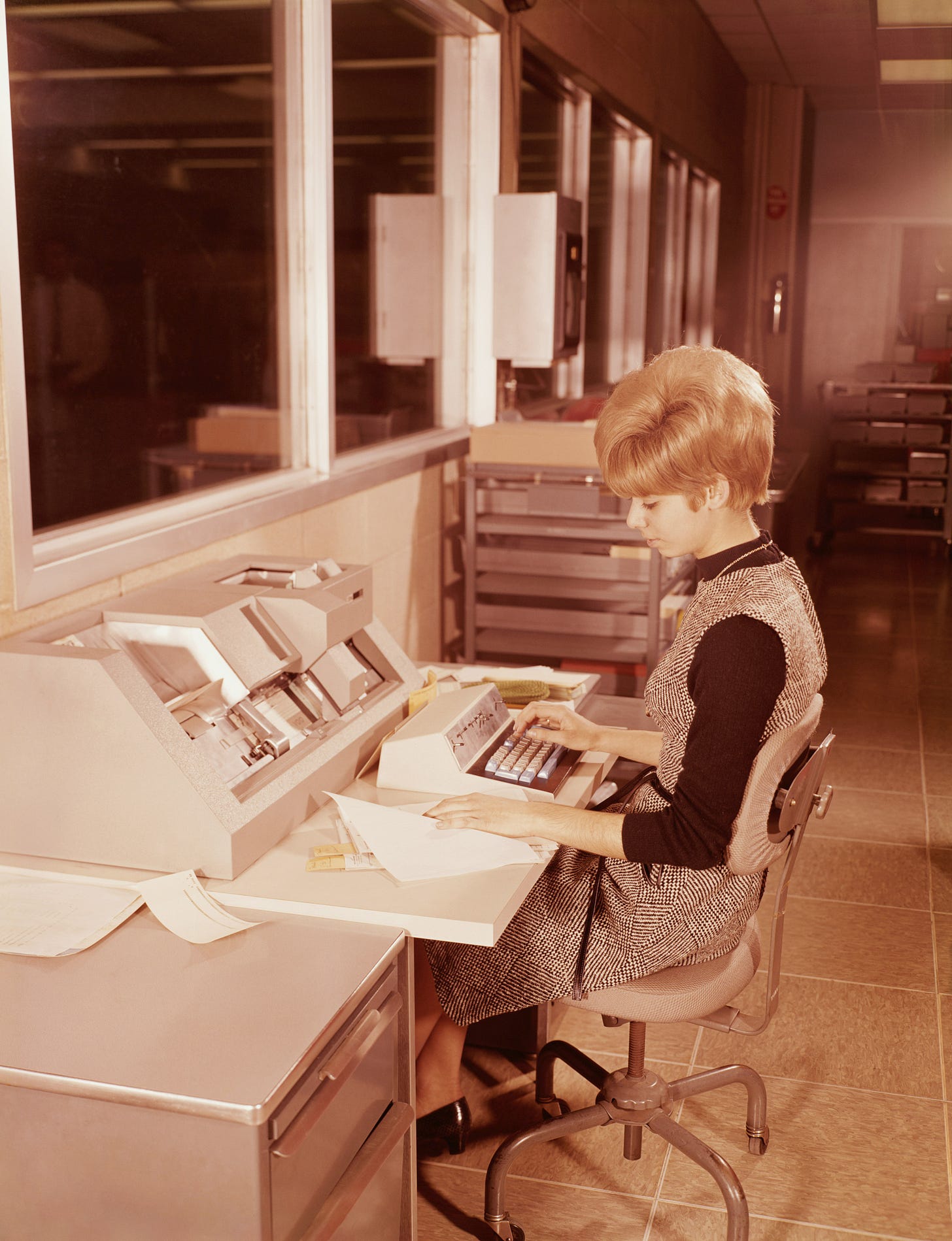 Image from 1970s of woman using a work processor.