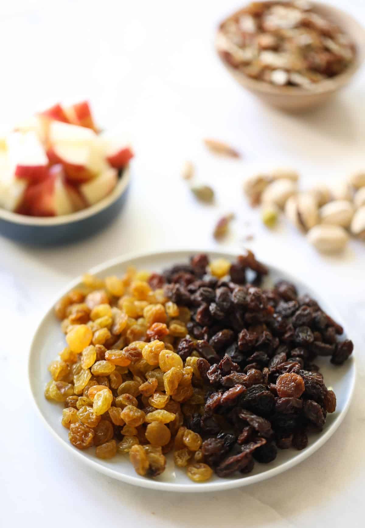 Raisins and apples and nuts laid out on a counter Raisins and apples and nuts laid out on a counter