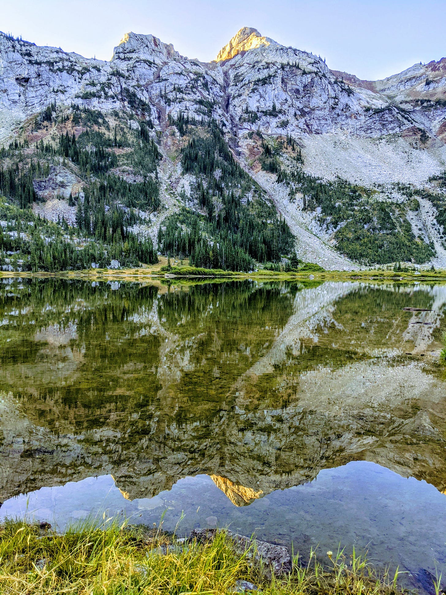 mountains reflecting in a shallow lake