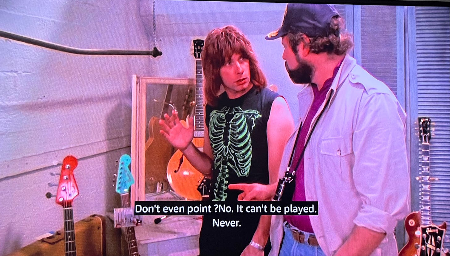 Image from This is Spinal Tap: Nigel showing Marty diBergi his guitars and when Marty says, “Don’t even point?” Nigel says, “No. It can’t be played.”
