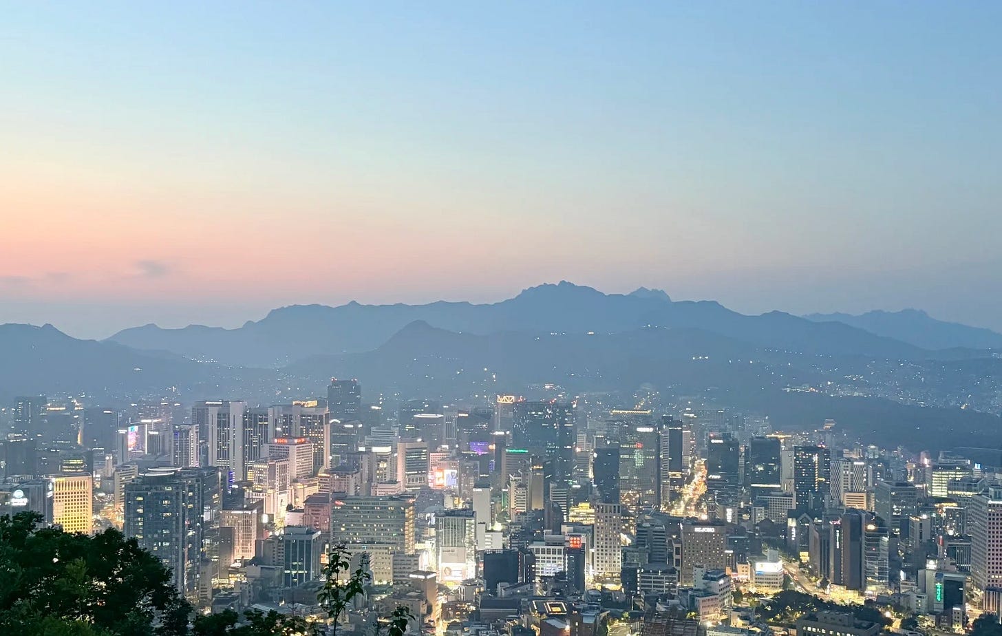 Seoul's downtown skyline at dusk, with the Bukhansan mountains on the horizon. Seoul's downtown skyline at dusk, with the Bukhansan mountains on the horizon.