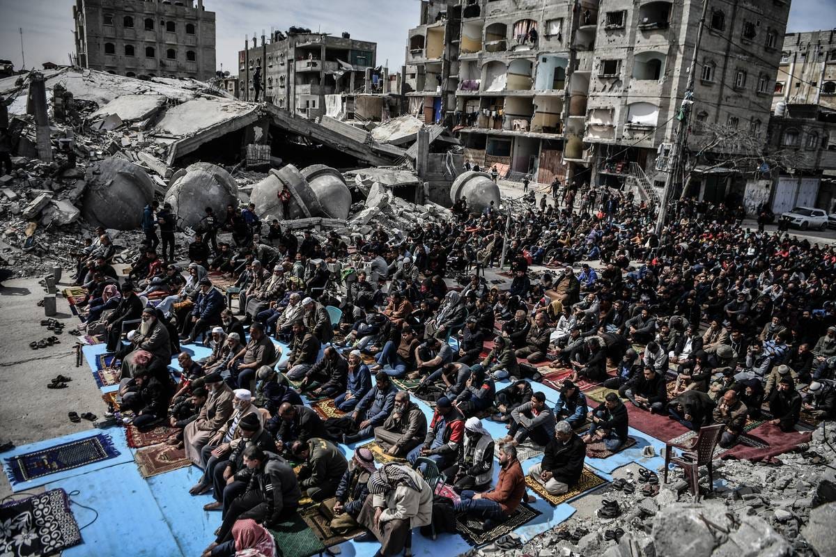 An aerial view of Palestinians performing Friday prayers among the rubble of the Al-Farooq Mosque, destroyed in an Israeli attack on March 01, 2024 in Rafah, Gaza.  [Abed Zagout - Anadolu Agency]
