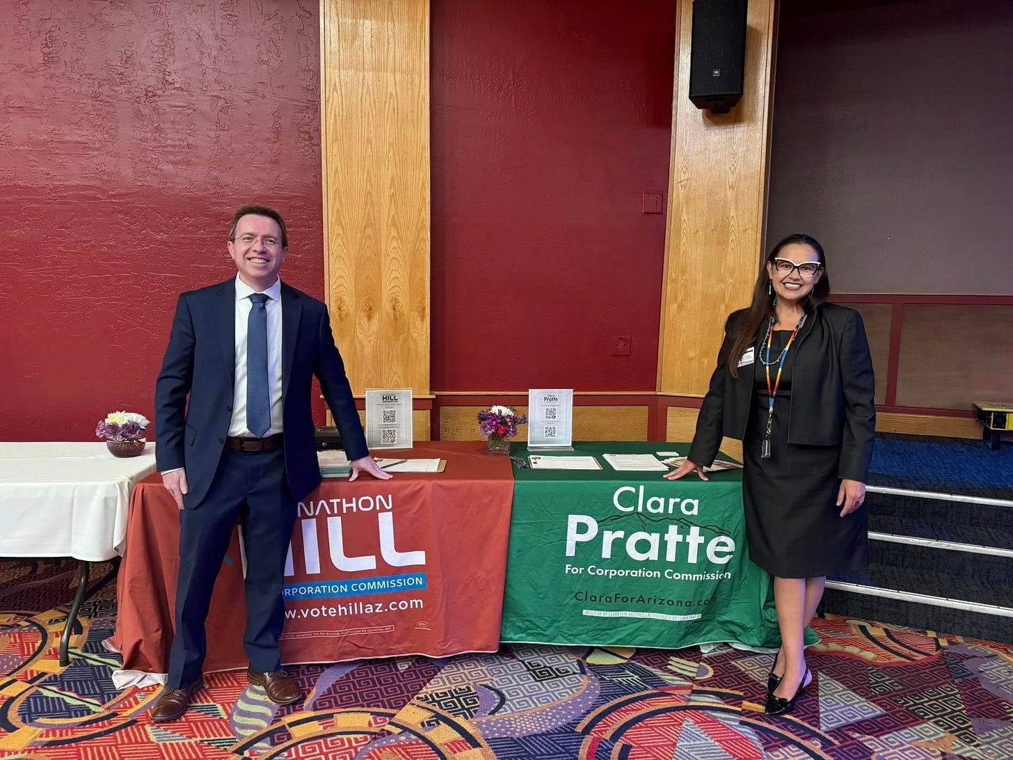 Clara Pratte and Jonathon Hill campaign with their campaign logos behind them. Clara Pratte and Jonathon Hill campaign with their campaign logos behind them.