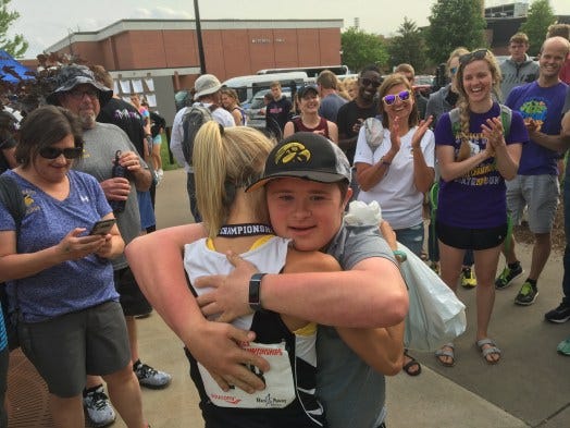 Denmark's Leah Kralovetz receives a hug from her brother, Travis, after winning the WIAA Division 2 girls state title in the 3,200-meter run.