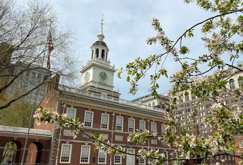 a large building with a clock tower with Maryland State House in the background a large building with a clock tower with Maryland State House in the background
