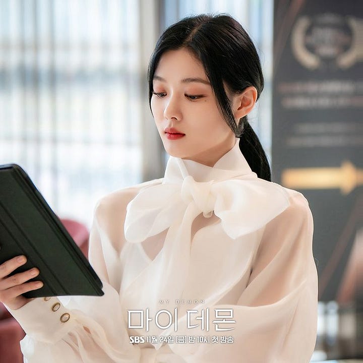 Two images of Song Kang and Kim Yoo Jung in their roles as Jeong Gu Won as director of the SunWol Foundation and Do Do Hee as CEO of the F&B Company.