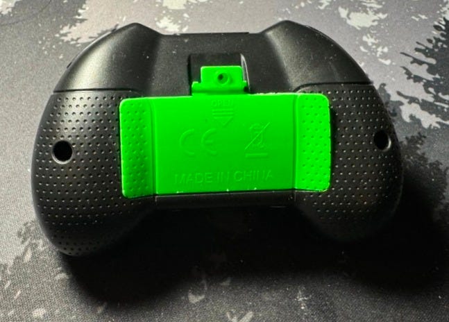 Controller back, assembled save for battery compartment retention screw