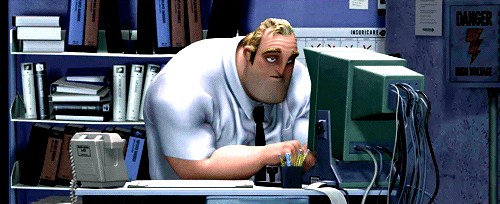 a man in a white shirt and tie leaning over a computer desk