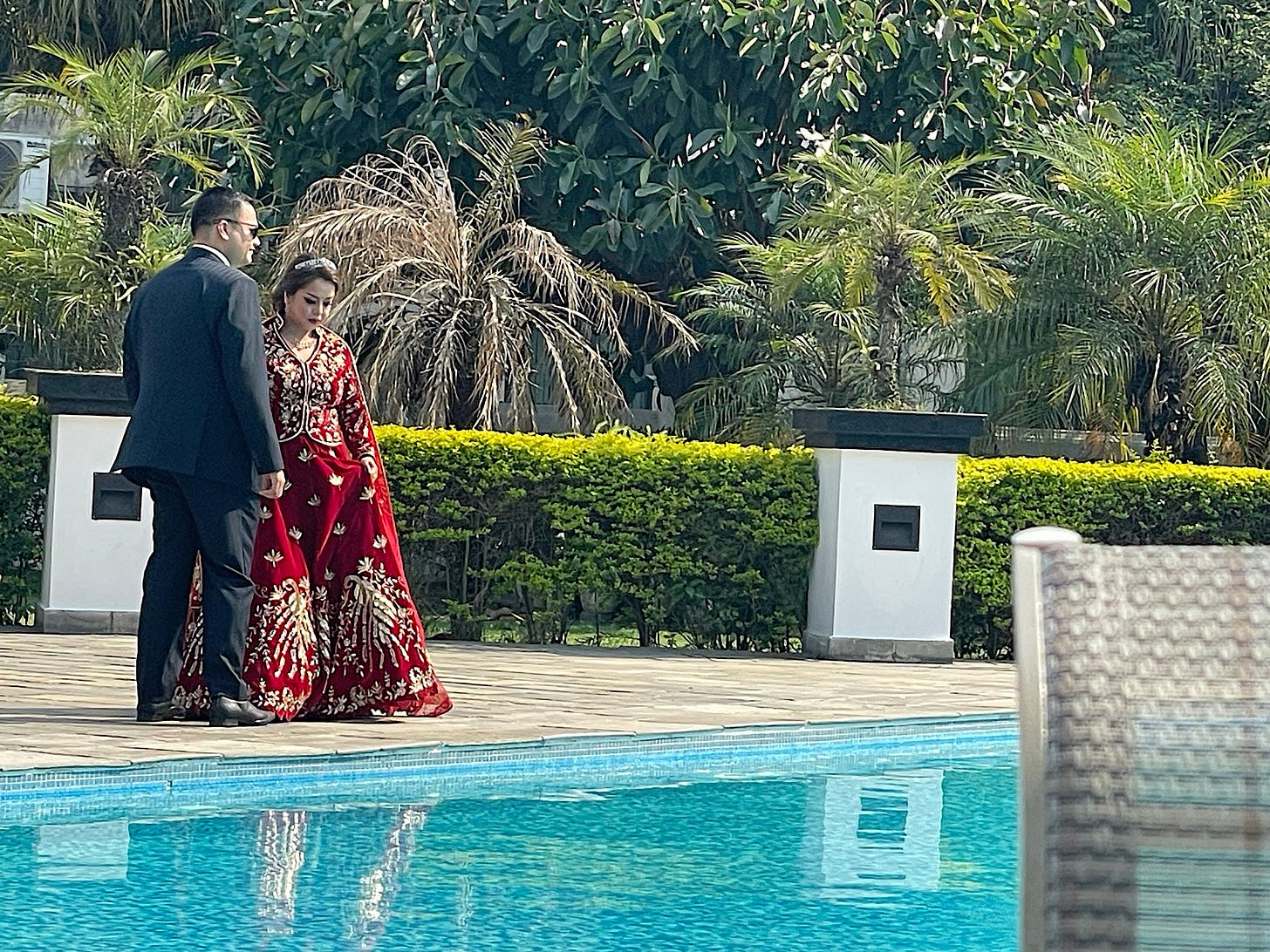 This wedding couple was doing a photo shoot by the pool.