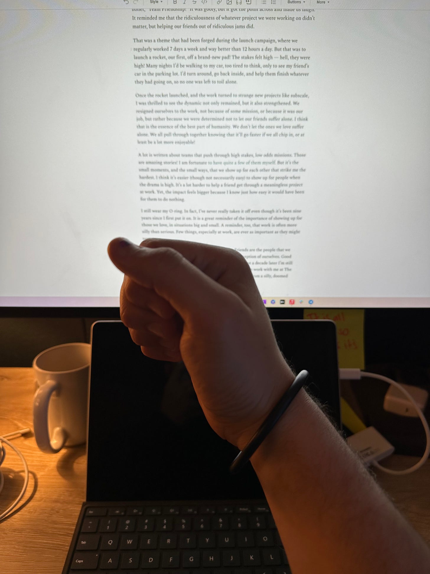 A hand held up with an O-ring around the wrist.