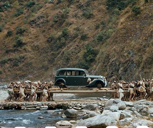 Porters transport a car on long poles across a stream in Nepal, 1948 - Rare  Historical Photos