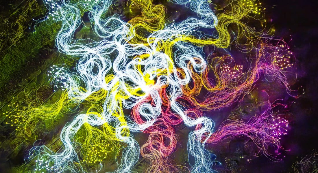 A group of wavy colourful lines with green lights around them A group of wavy colourful lines with green lights around them