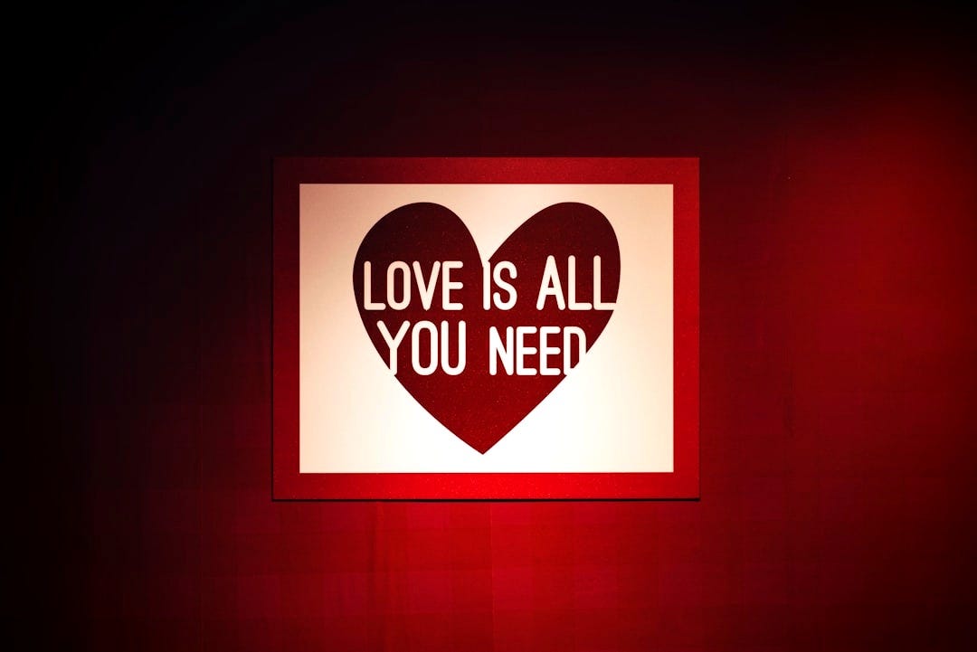 a picture of a heart on a wall with the words love is all you need a picture of a heart on a wall with the words love is all you need