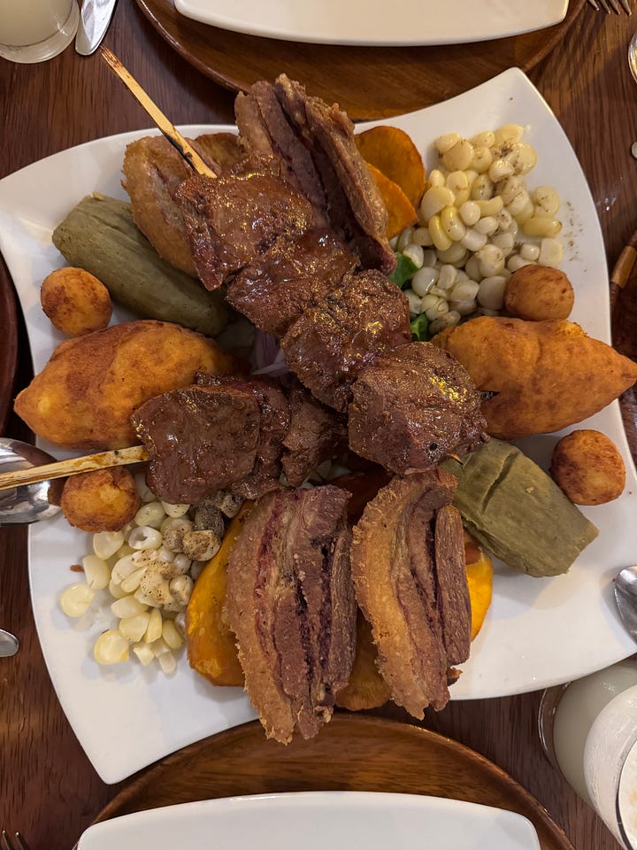 Lomo saltado, seco de res, an appetizer platter for two (armies), pisco sour