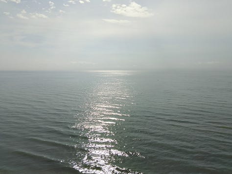 Three sunrise photographs from my solo trip to Cha-am, Thailand, showing calm ocean water, changing morning skies, and light reflecting across the sea.