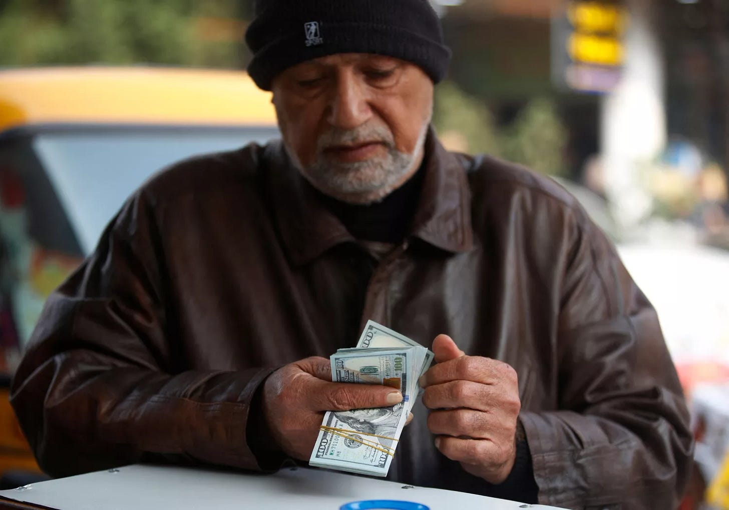 Person counting US dollar bills