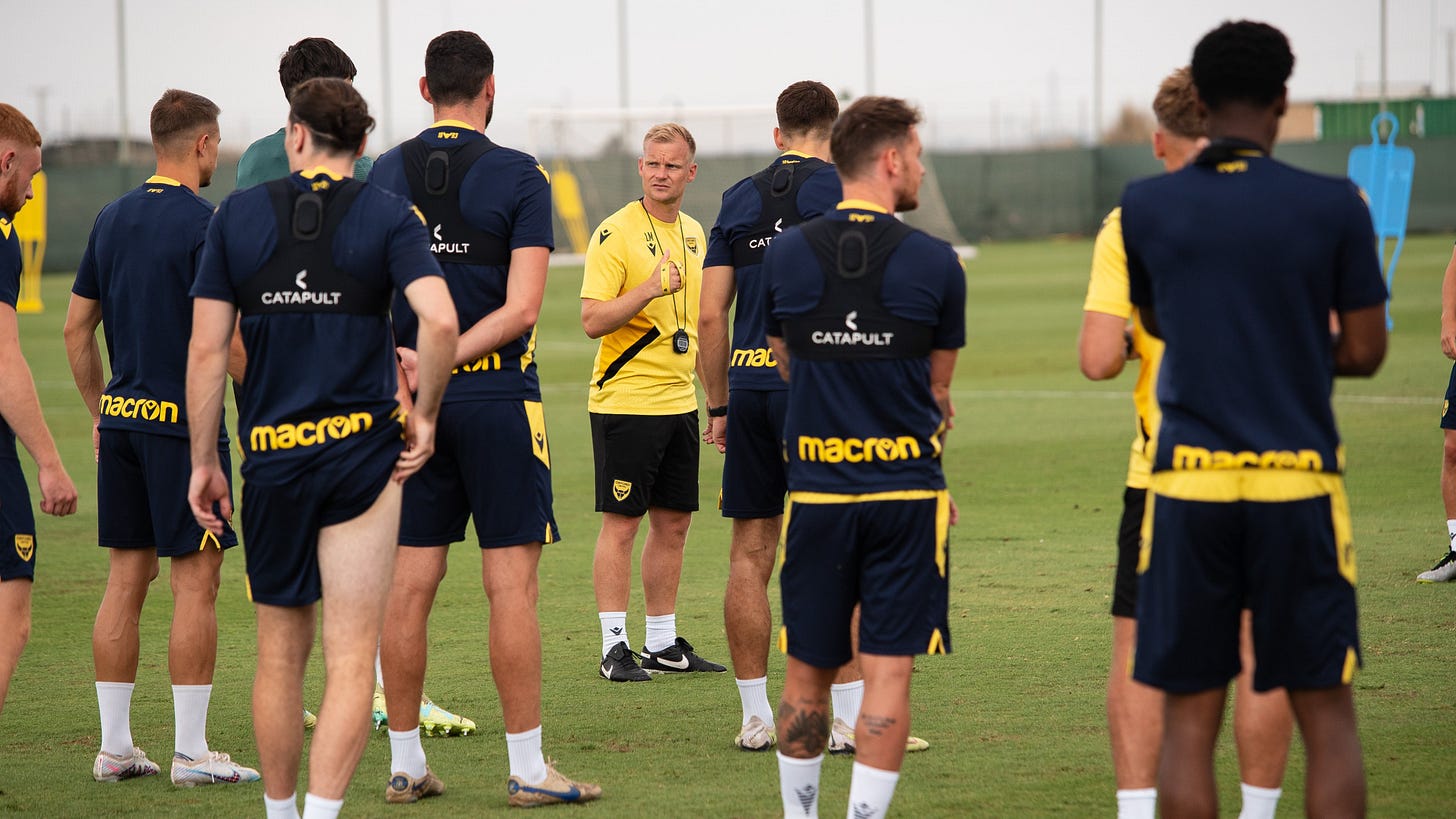 Liam Manning addresses the team on day four of pre-season camp in Spain.