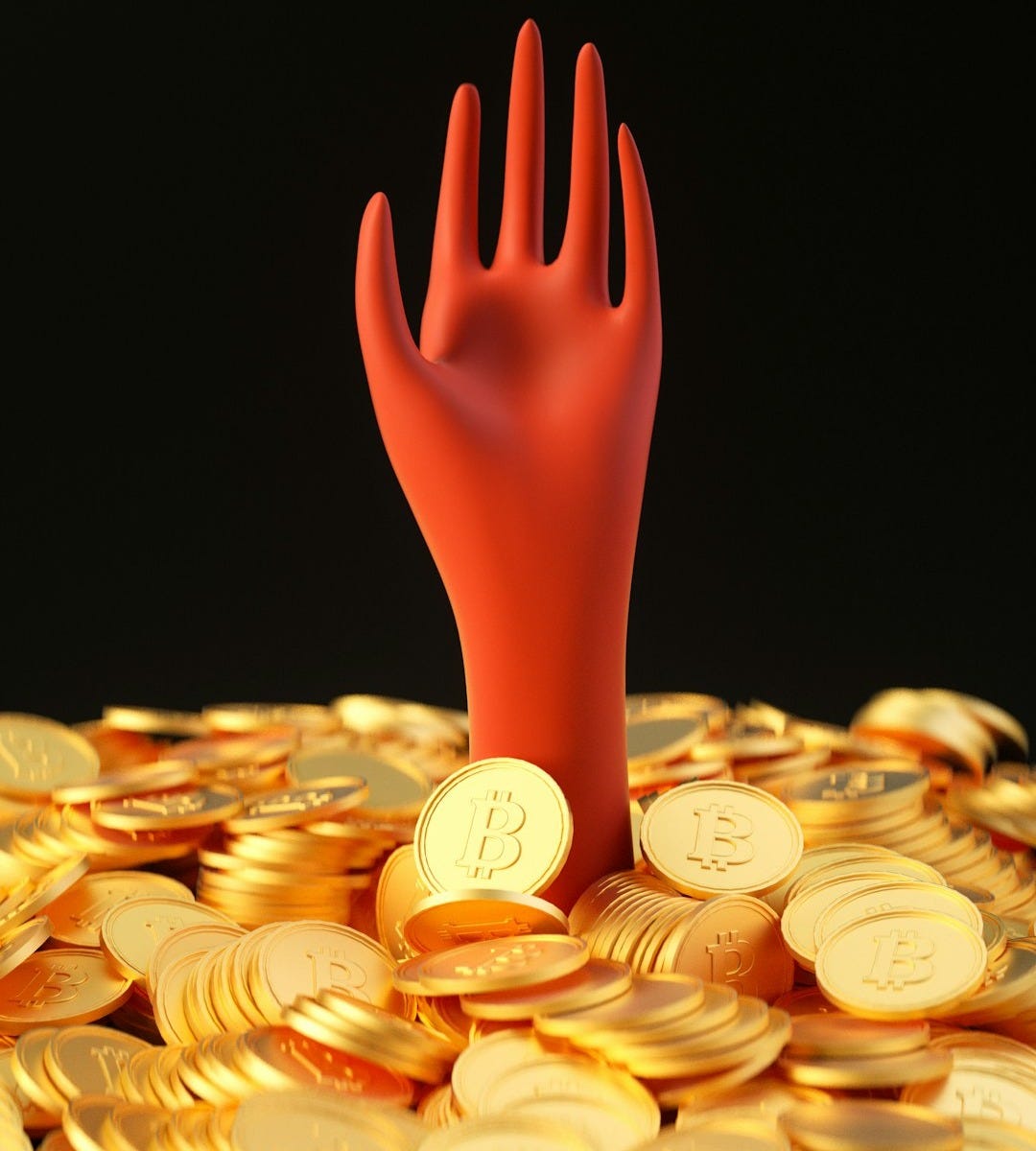 a pile of gold coins with a red hand sticking out of it