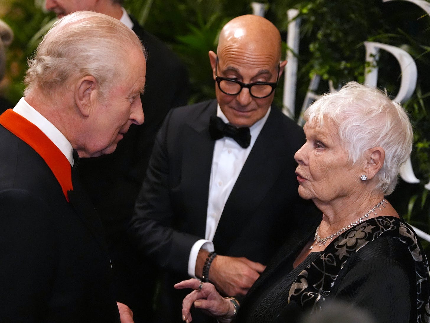 King Charles talking with Judi Dench and Stanley Tucci