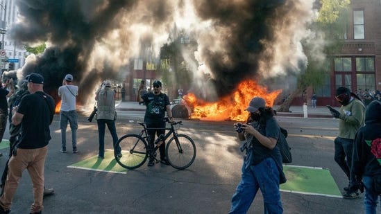 LA rioters set police cruiser on fire by lighting objects and dropping them  | Video - Hindustan Times