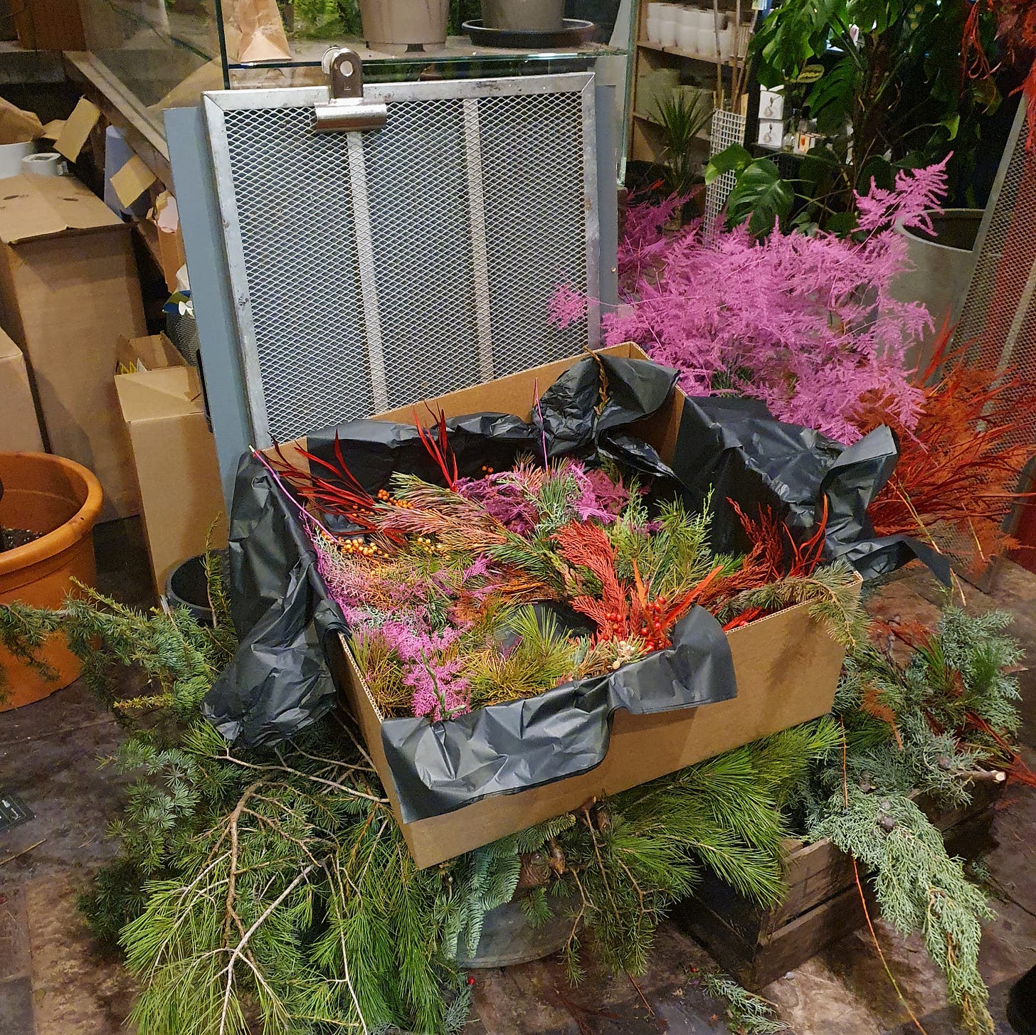 A colourful Christmas wreath in a cardboard box