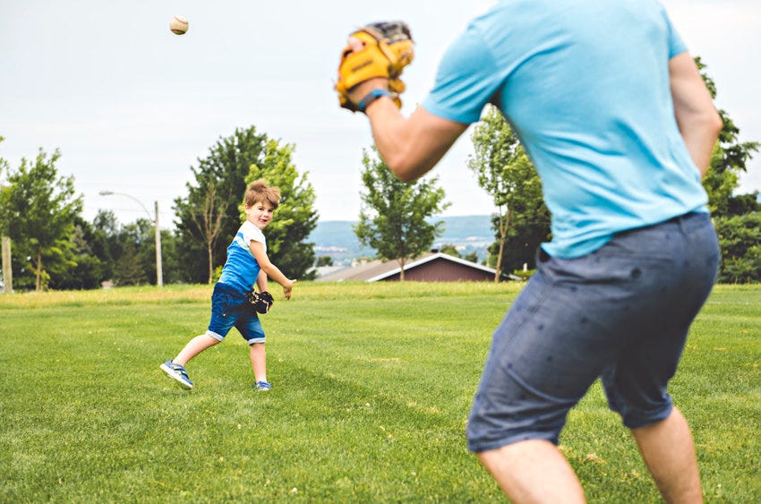 Dad playing baseball with his son